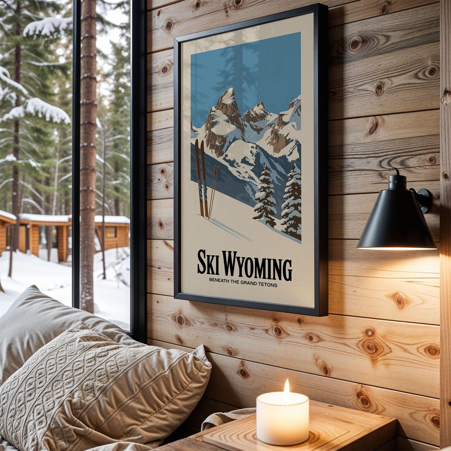 A framed poster of a snowy mountain landscape hangs on a wooden wall, with a cozy bed and a lit candle in the foreground.