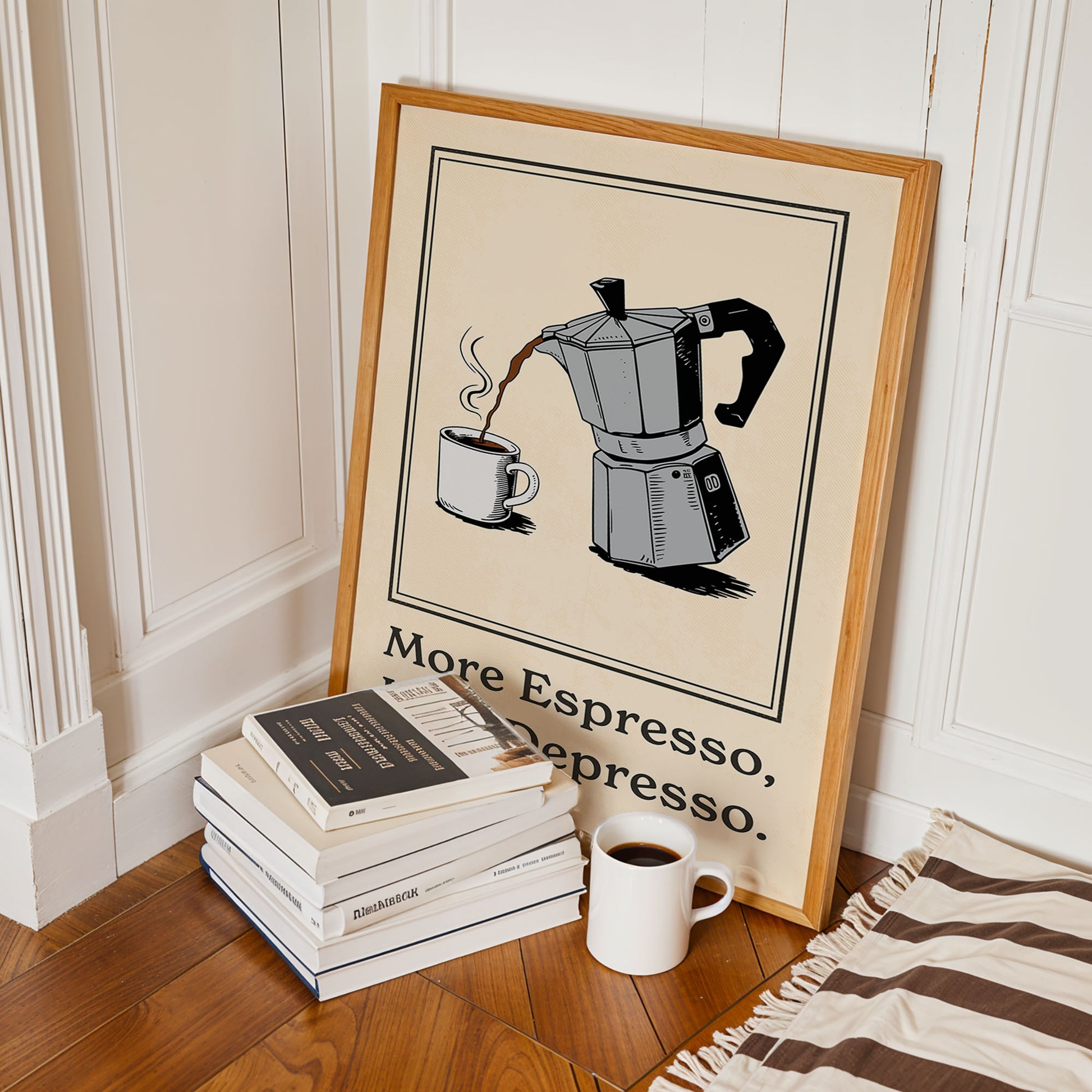 A framed poster of a coffee maker with the text "More Espresso, Represso" is displayed on a wooden floor next to a stack of books and a white mug.