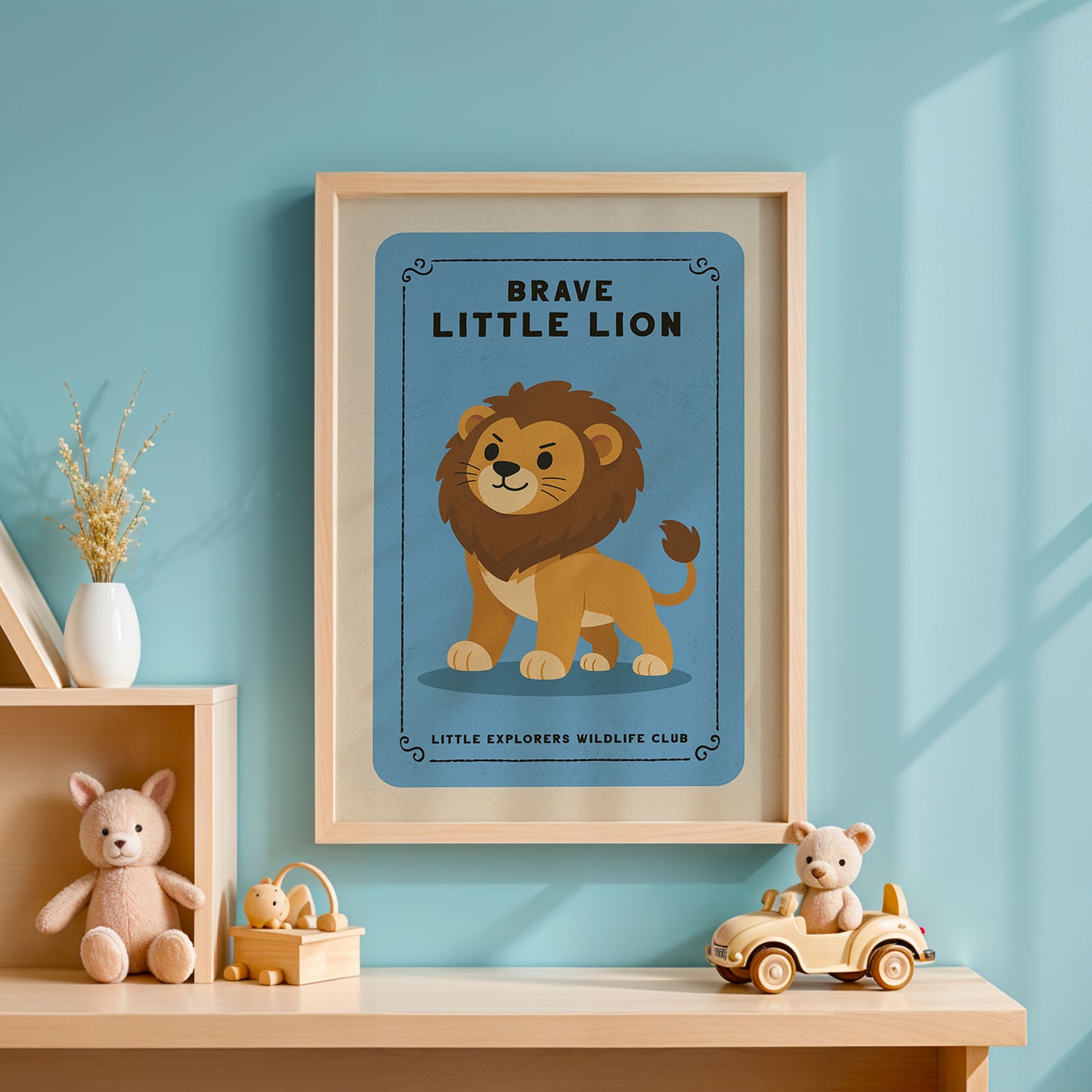 a framed poster of a lion on a blue background, with the text "BRAVE LITTLE LION" and "LITTLE EXPLORERS WILDLIFE CLUB" below it. The poster is hanging on a wall, and there are some toys and decorative items placed nearby.