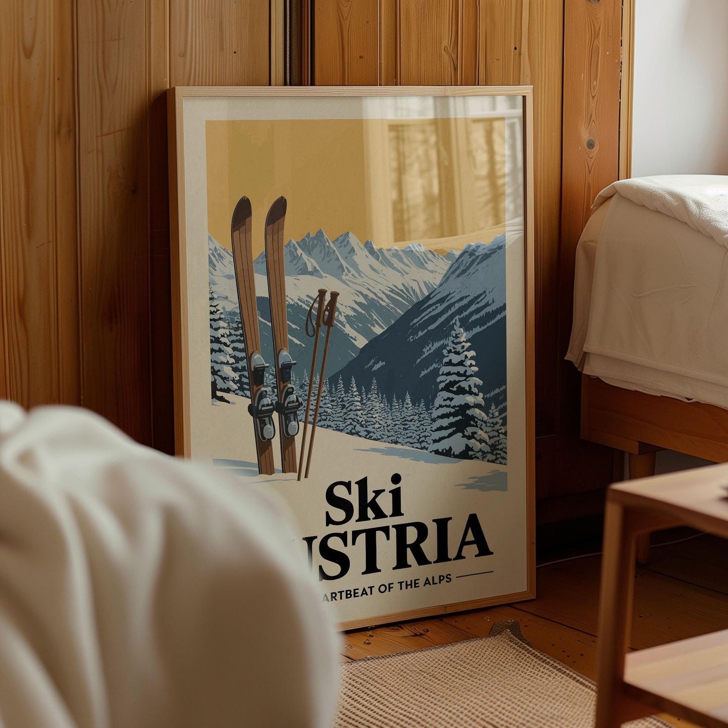 A framed poster of a snowy mountain landscape with skis and ski poles, featuring the text "Ski Austria" and "ARTBEAT OF THE ALPS".