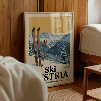 A framed poster of a snowy mountain landscape with skis and ski poles, featuring the text "Ski Austria" and "ARTBEAT OF THE ALPS".