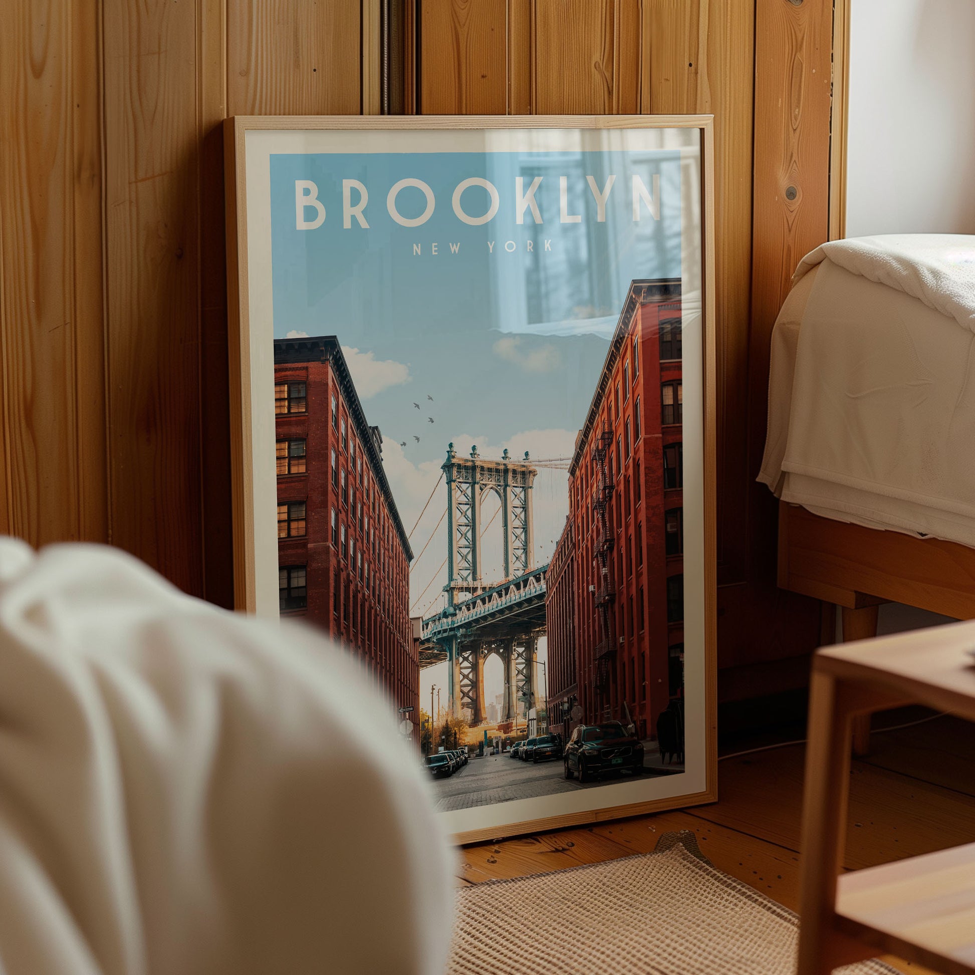A framed poster of the Manhattan Bridge in New York City is displayed in a room with wooden paneling.