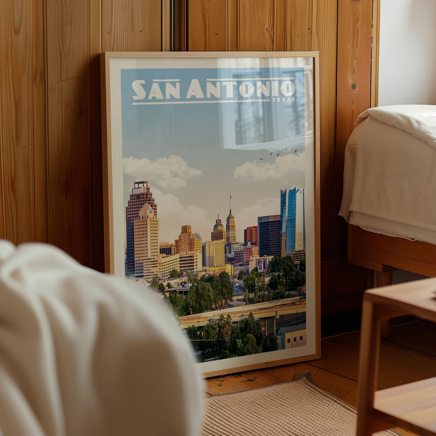 A framed poster of the San Antonio skyline in Texas, featuring a cityscape with tall buildings and a bridge.