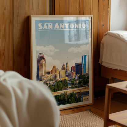 A framed poster of the San Antonio skyline in Texas, featuring a cityscape with tall buildings and a bridge.