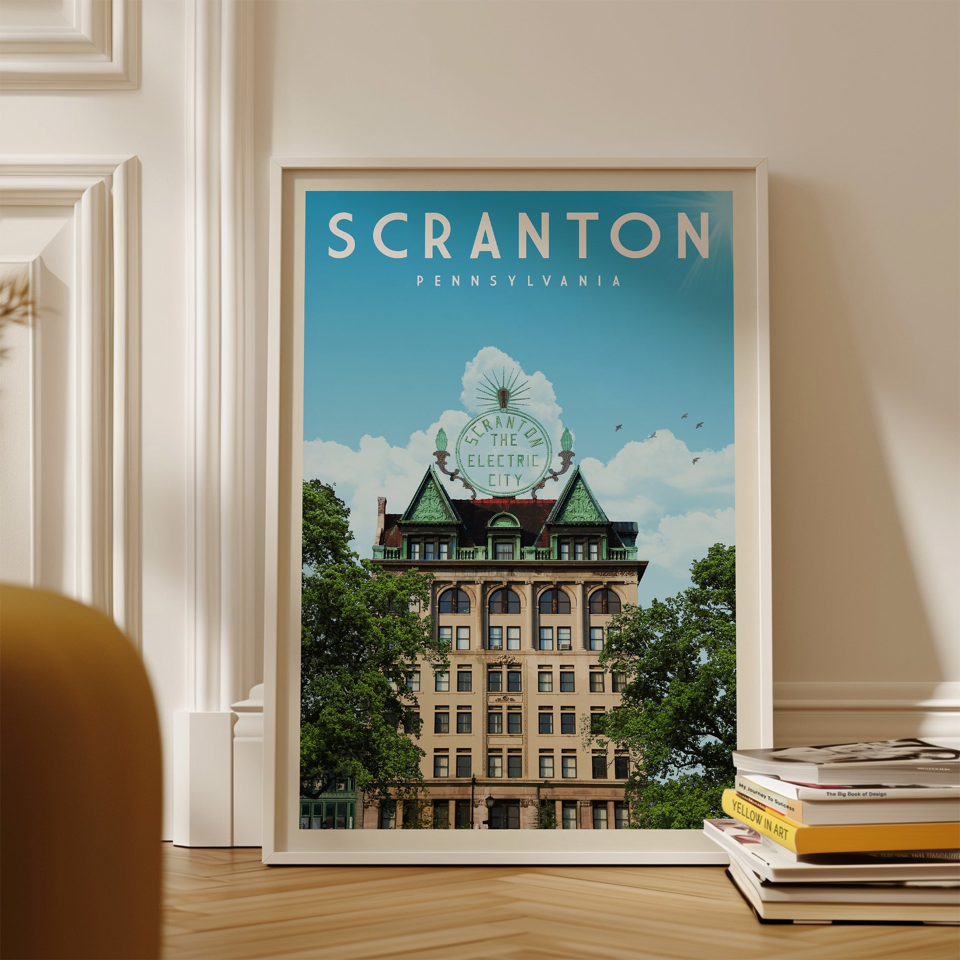 A framed poster of a building with a green roof and a sign that says "Scranton, Pennsylvania" is displayed on a wall.