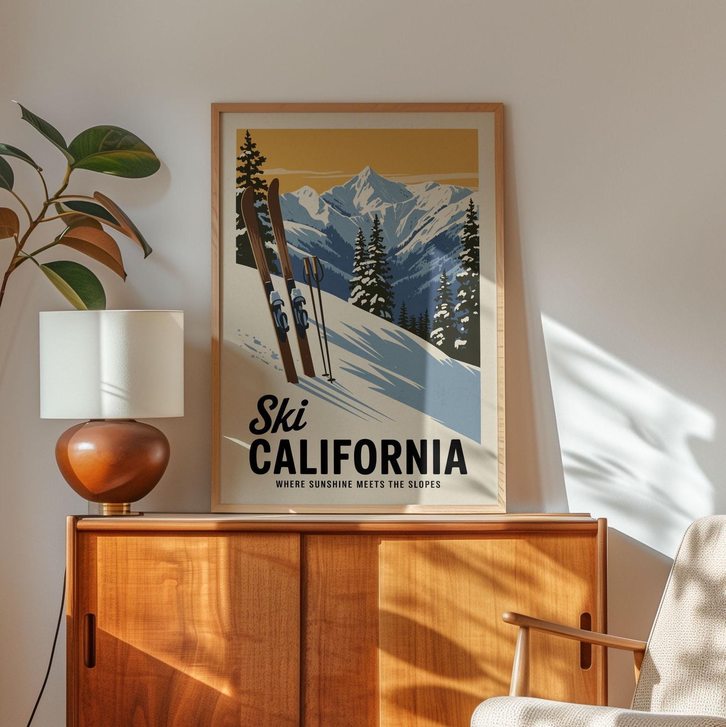 A framed poster of a snowy mountain landscape with skiers is displayed on a wooden cabinet, accompanied by a lamp and a plant in the corner of the room.