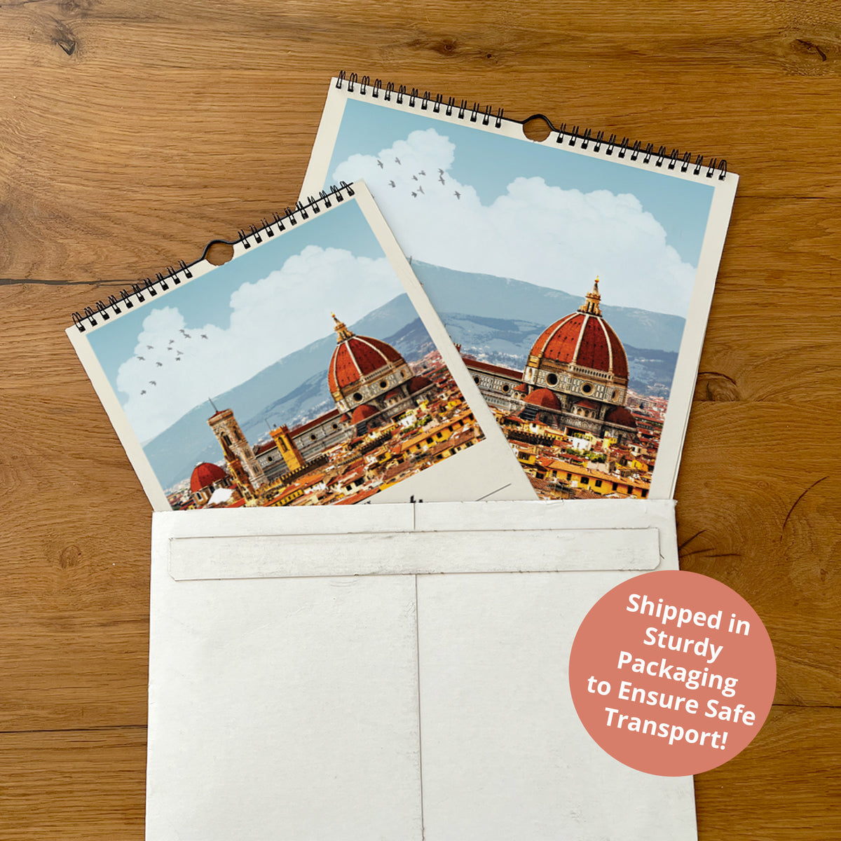 a pair of calendar pages with a cityscape image on them, placed inside a white envelope on a wooden surface.