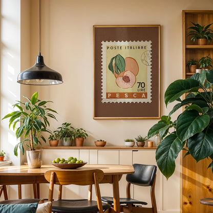 a cozy dining area with a wooden table, chairs, and a potted plant. A framed stamp with a peach and the text &quot;POSTE ITALIERE 70 LIRE PESCA&quot; hangs on the wall above the table.
