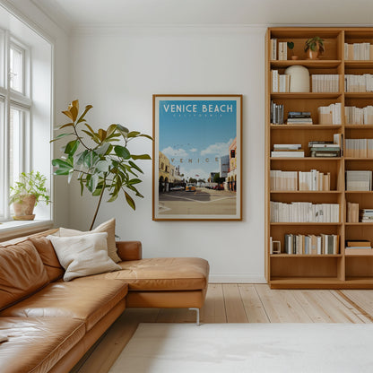 a cozy living room with a large bookshelf filled with books, a comfortable leather couch, and a framed poster of Venice Beach, California.