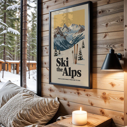 A framed poster of a snowy mountain landscape with the text "Ski the Alps" hangs on a wooden wall, with a cozy couch and a lit candle in the foreground.