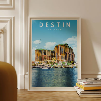 A framed poster of a large hotel complex in Destin, Florida, with a body of water in the foreground.