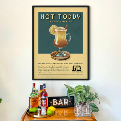 a framed advertisement for a "Hot Toddy" cocktail, accompanied by a wooden bar display with various liquor bottles and glasses.