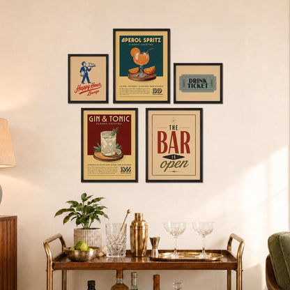 a wall display with framed vintage advertisements for a bar and a cocktail lounge, along with a wooden bar cart and various cocktail-making accessories.
