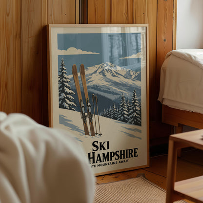 A framed poster of a snowy mountain landscape with skis and trees, advertising Ski Hampshire, is displayed in a room with a wooden wall.