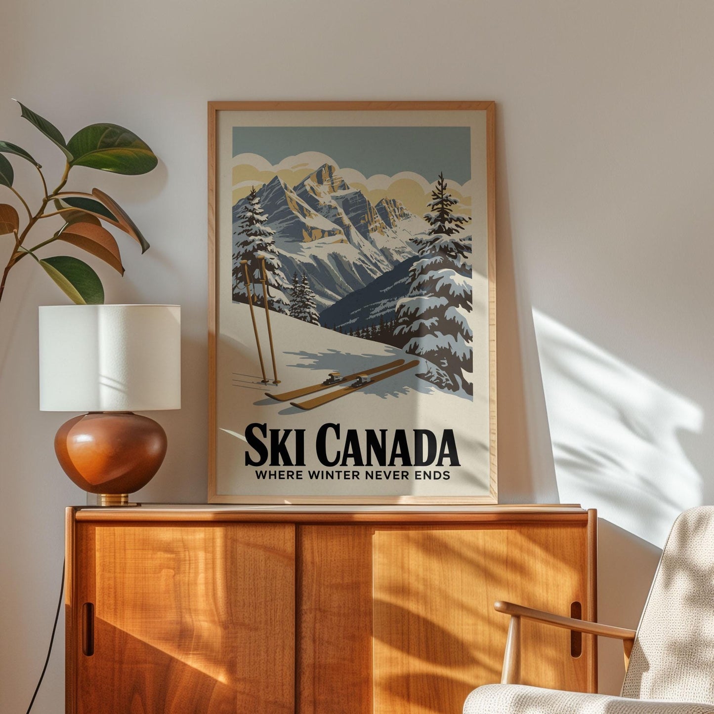 A framed poster of a snowy mountain landscape with skis and ski poles, hanging on a wall above a wooden cabinet.
