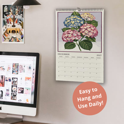 a wall with a calendar and a computer monitor on it. The calendar displays a floral design, and the computer monitor shows a webpage. There is also a text overlay that reads "Easy to Hang and Use Daily!"