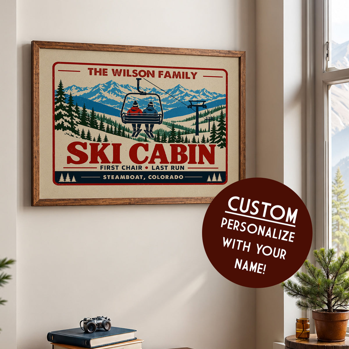 a framed poster of a ski cabin with a ski lift, along with a circular sticker that says "CUSTOM PERSONALIZE WITH YOUR NAME!"
