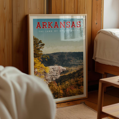 A framed poster of a scenic mountain landscape with the text "ARKANSAS THE LAND OF OPPORTUNITY" prominently displayed.