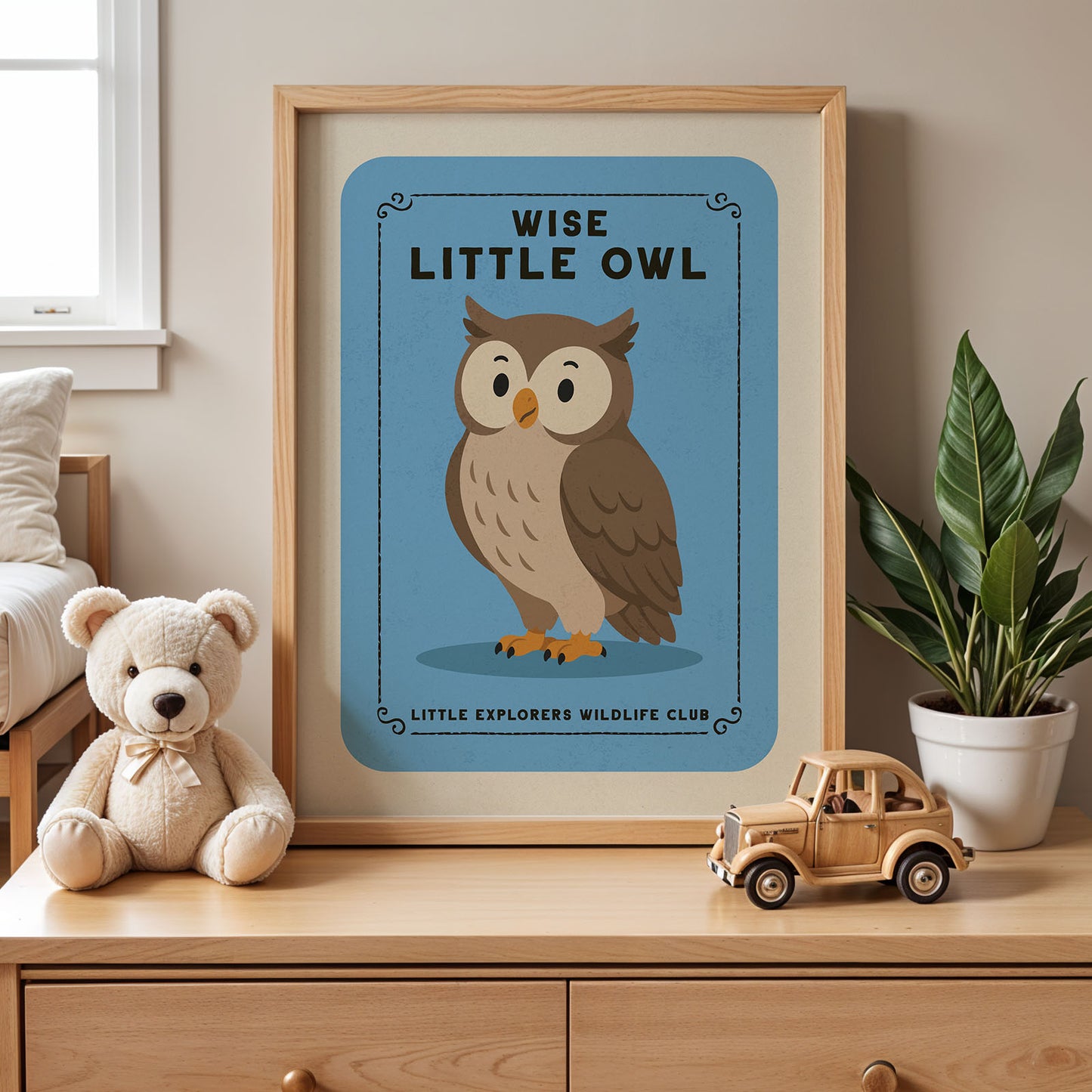 a framed poster of an owl with the text "WISE LITTLE OWL" and "LITTLE EXPLORERS WILDLIFE CLUB" on it, placed on a wooden dresser next to a stuffed teddy bear and a toy truck.