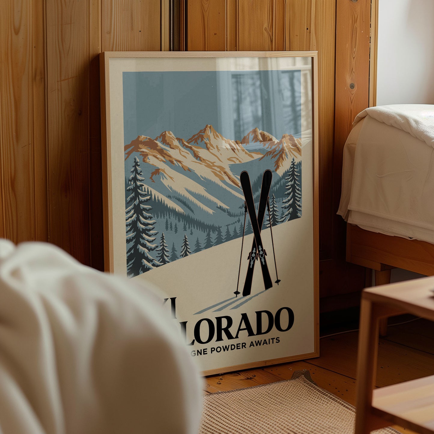 A framed poster of a mountain landscape with ski equipment, advertising "Colorado Powder Awaits".