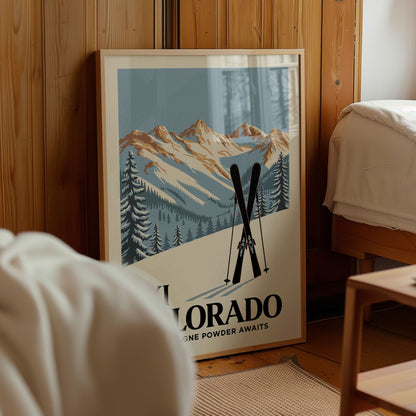 A framed poster of a mountain landscape with ski equipment, advertising "Colorado Powder Awaits".