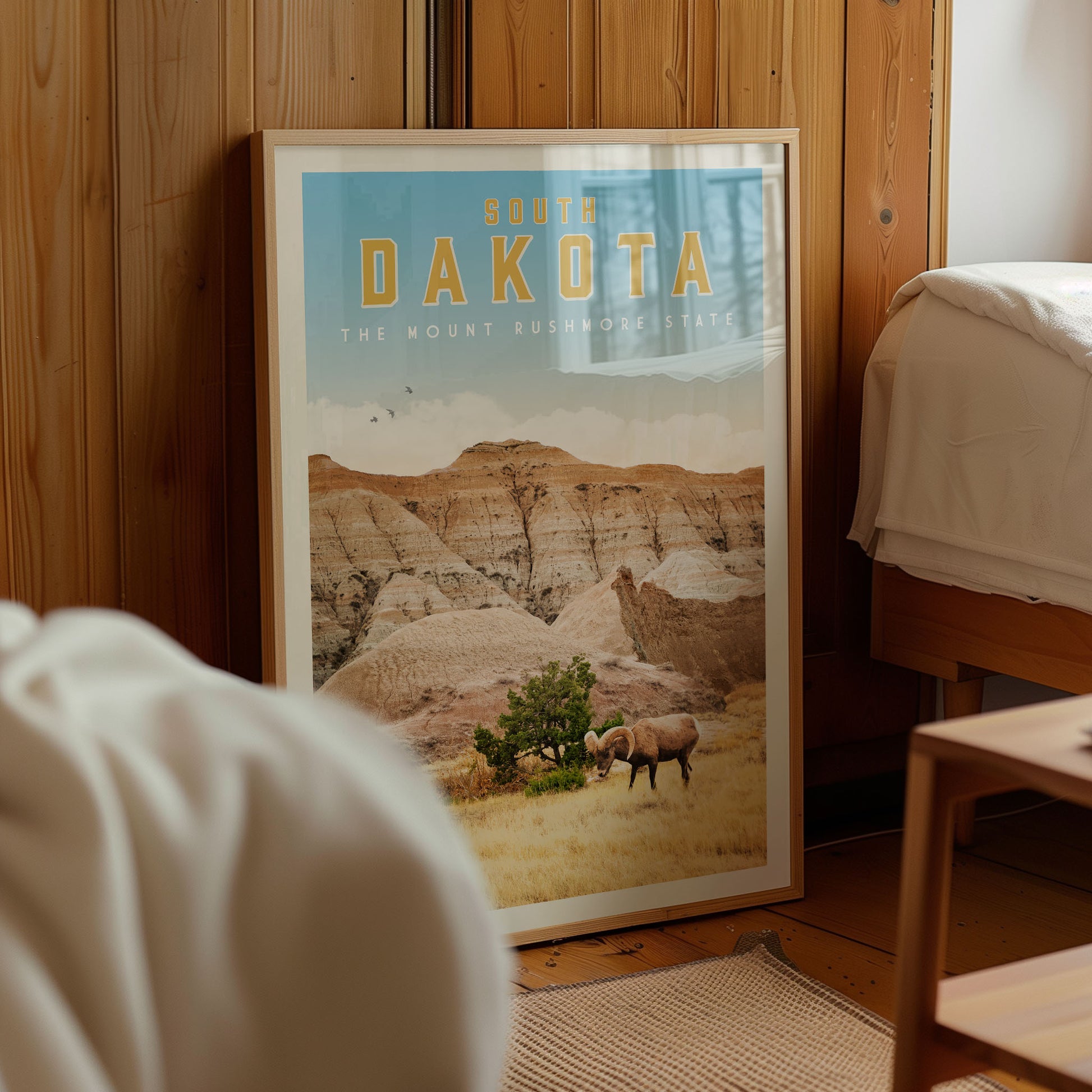 a framed poster of a scenic landscape with a mountain range and a herd of animals grazing in the foreground.