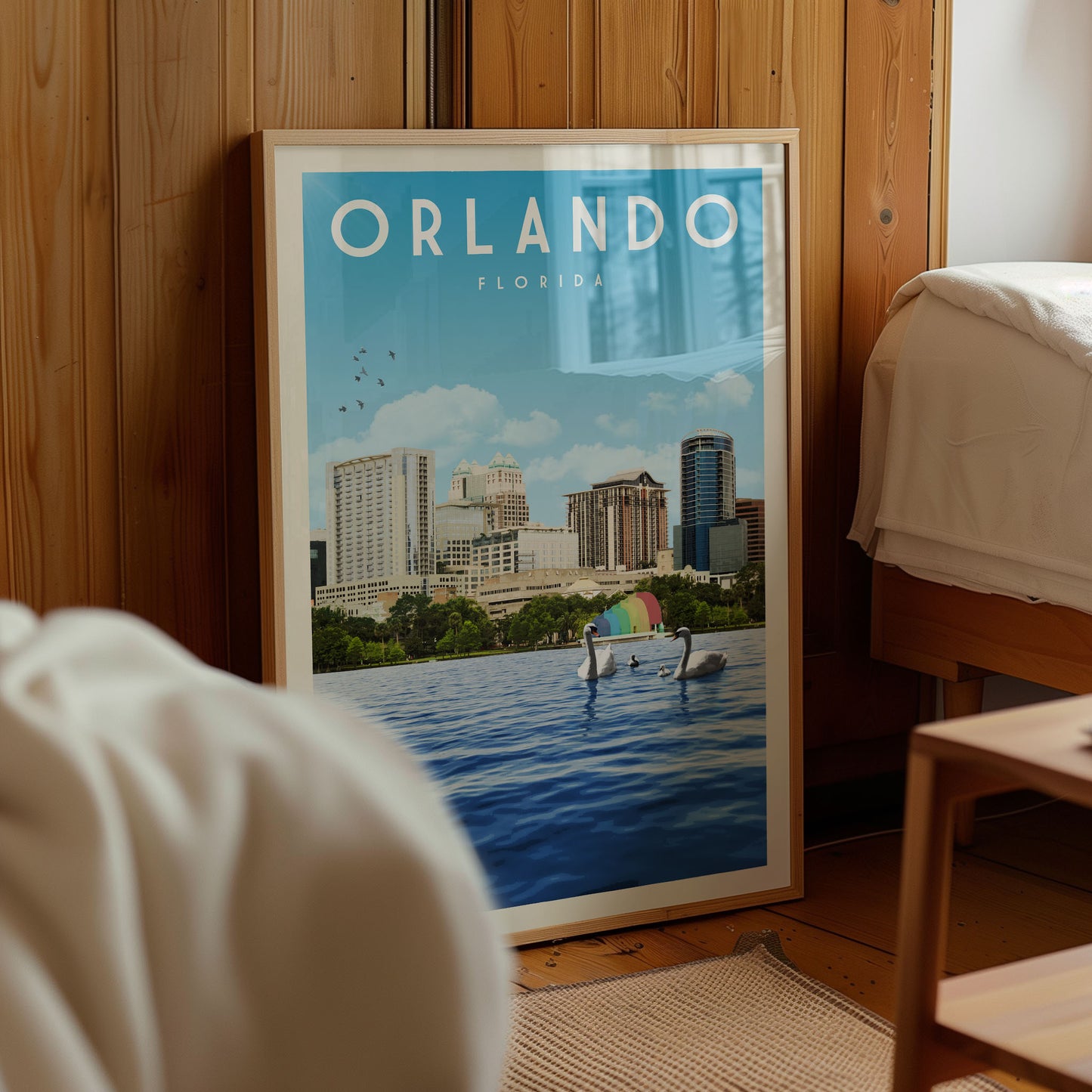 A framed poster of the Orlando, Florida skyline with a body of water and swans in the foreground.