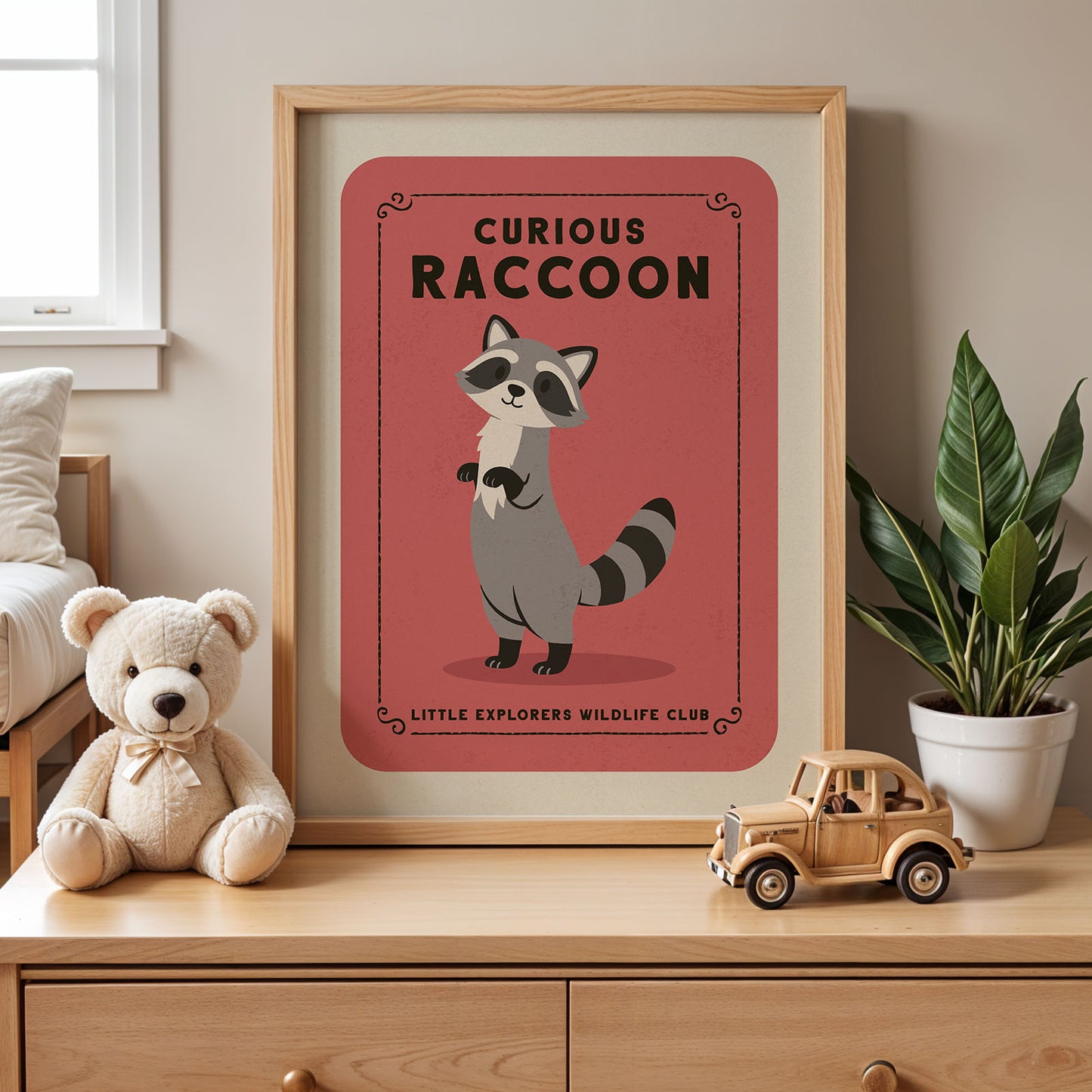 a framed poster of a raccoon, a stuffed teddy bear, and a toy truck on a wooden dresser.