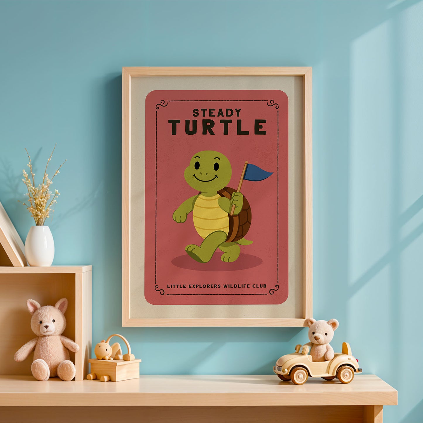 a framed poster of a smiling turtle holding a flag, with the title "Steady Turtle" and the text "Little Explorers Wildlife Club" below it. The poster is displayed on a blue wall, and there are some toys and decorative items in the foreground, including a stuffed animal and a toy car.
