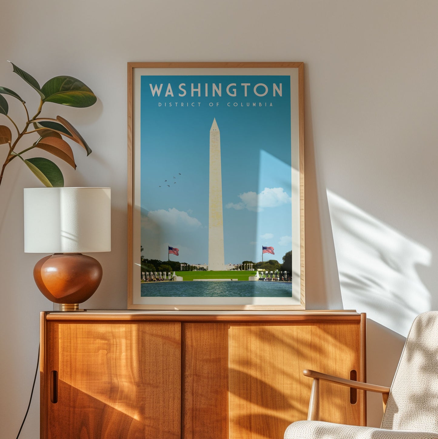 a framed poster of Washington, D.C., with the Washington Monument and the District of Columbia in the background, displayed on a wooden cabinet.