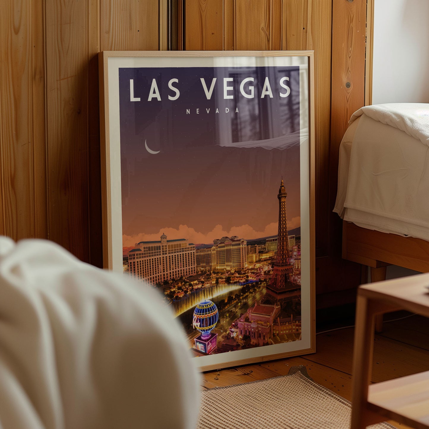 A framed poster of Las Vegas, Nevada, featuring the iconic Las Vegas Strip and the Bellagio Hotel, is displayed in a room.