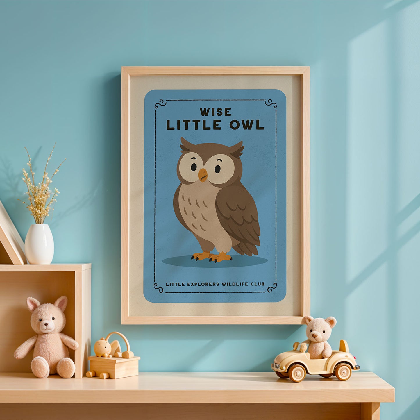 a framed poster of an owl on a blue background, with the text "WISE LITTLE OWL" and "LITTLE EXPLORERS WILDLIFE CLUB" below it. The poster is hanging on a wall, and there are some toys and decorative items placed nearby.