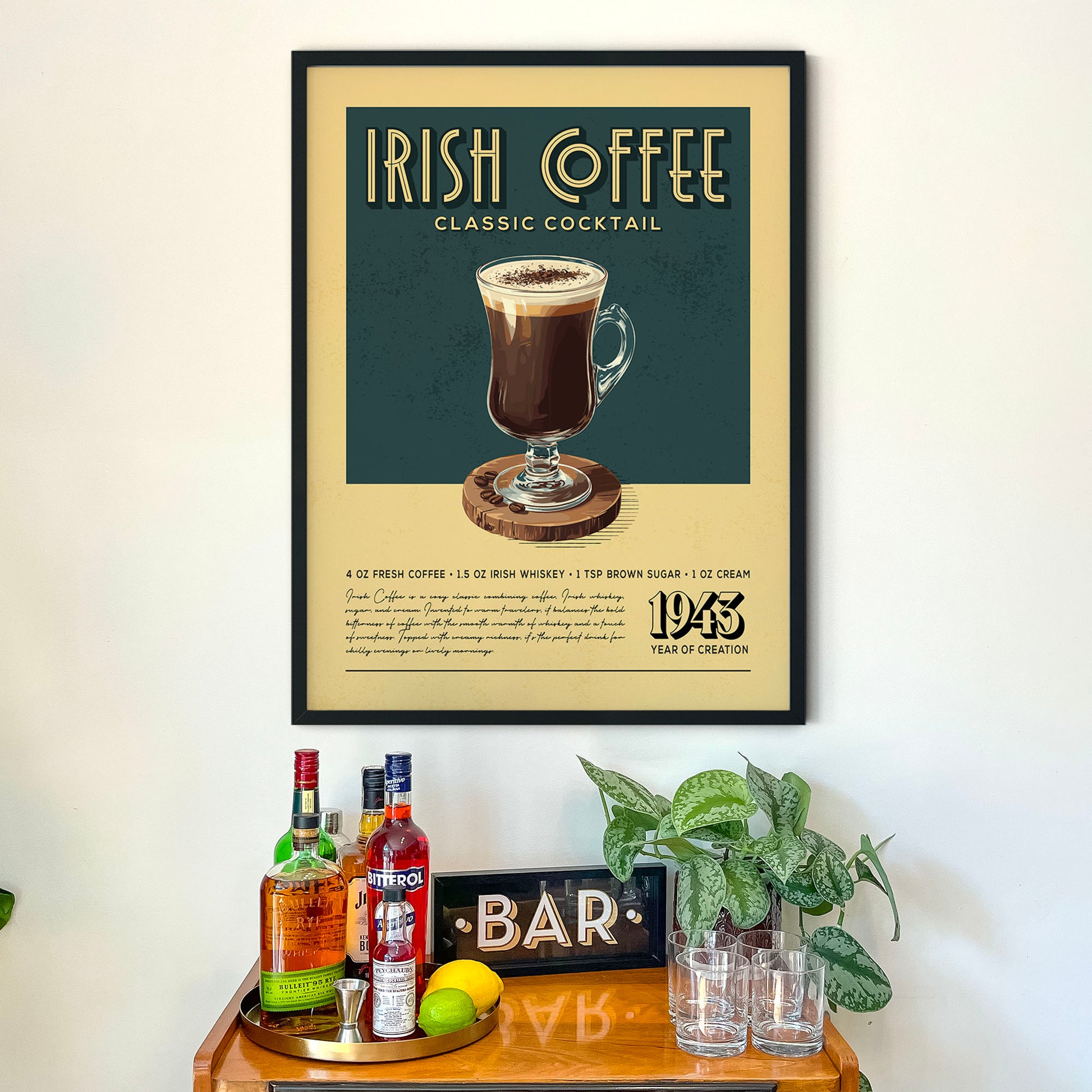 a framed poster advertising an Irish Coffee cocktail, with a wooden bar counter below it displaying various alcoholic beverages and a potted plant.