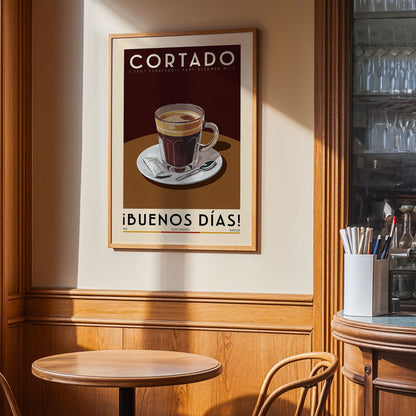 a framed poster of a cup of coffee on a table, with the text "CORTADO" and "IBUENOS DÍAS!" displayed prominently.
